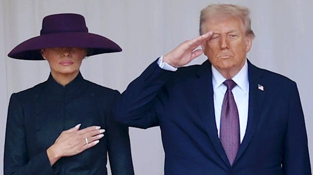 (from left to right) Melania Trump, wearing a long dress and purple hat covering her eyes has her hand across her chest and is stood next to Donald Trump who is saluting