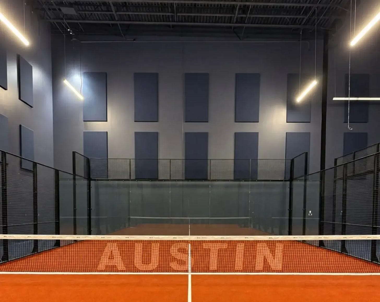 The terracotta court, with AUSTIN across the net