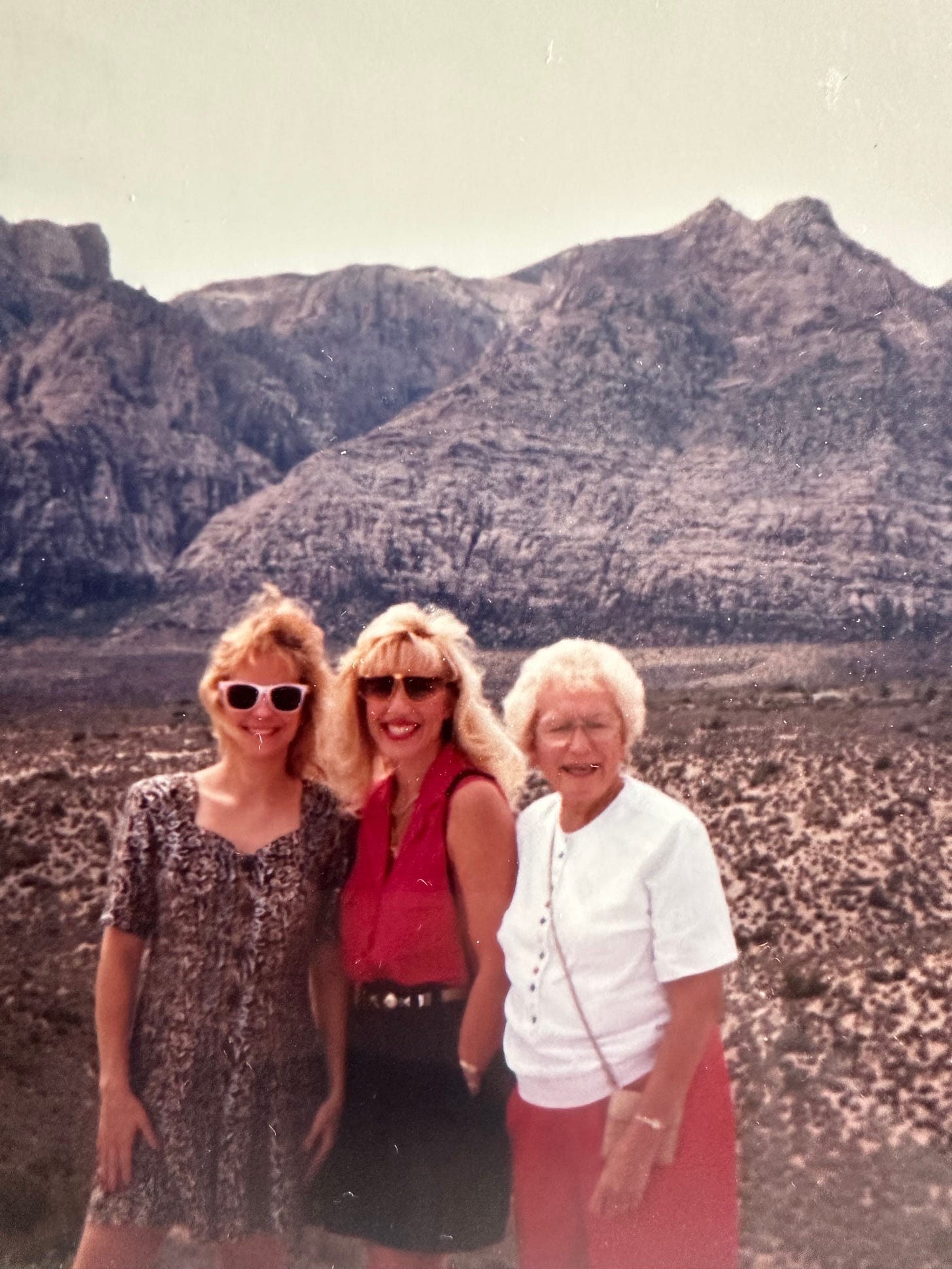 Mom & Two Daughters posing by the mountains