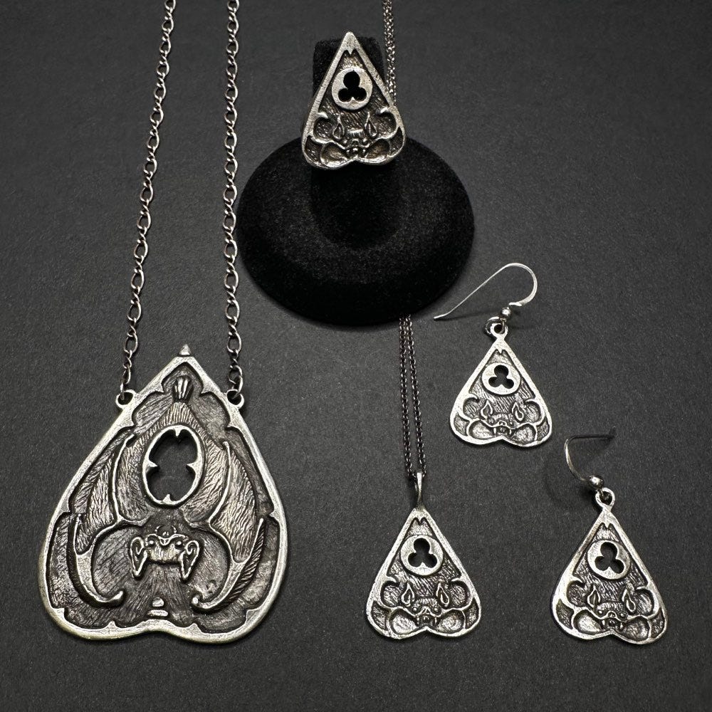 A selection of silver pendants in bat shapes