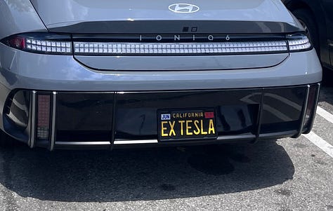 License plates reading DOGGRL, EX TESLA, SXYNURS, 2HENTAI, FEMD❤️M, and DZOOGOO