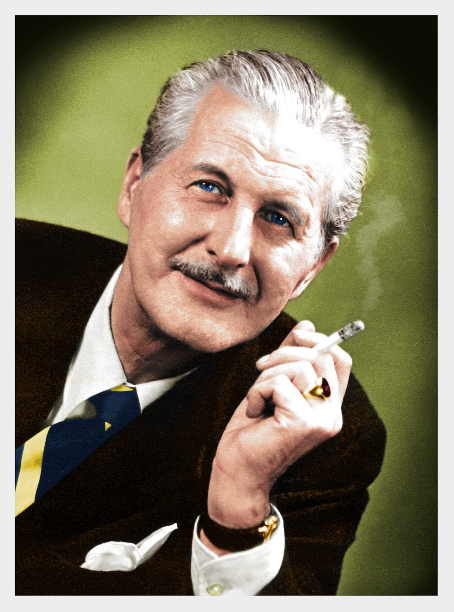 A man with blue eyes, grey hair and a moustache smoking a cigarette. A man with blue eyes, grey hair and a moustache smoking a cigarette.