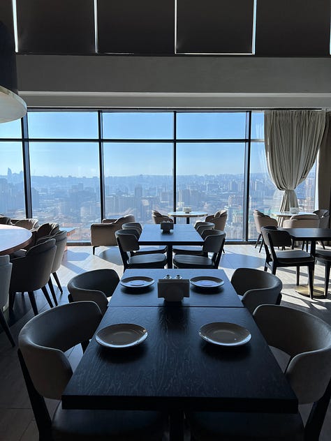 Adnan and I at the high-rise café, plus my confirmation of my flight change.