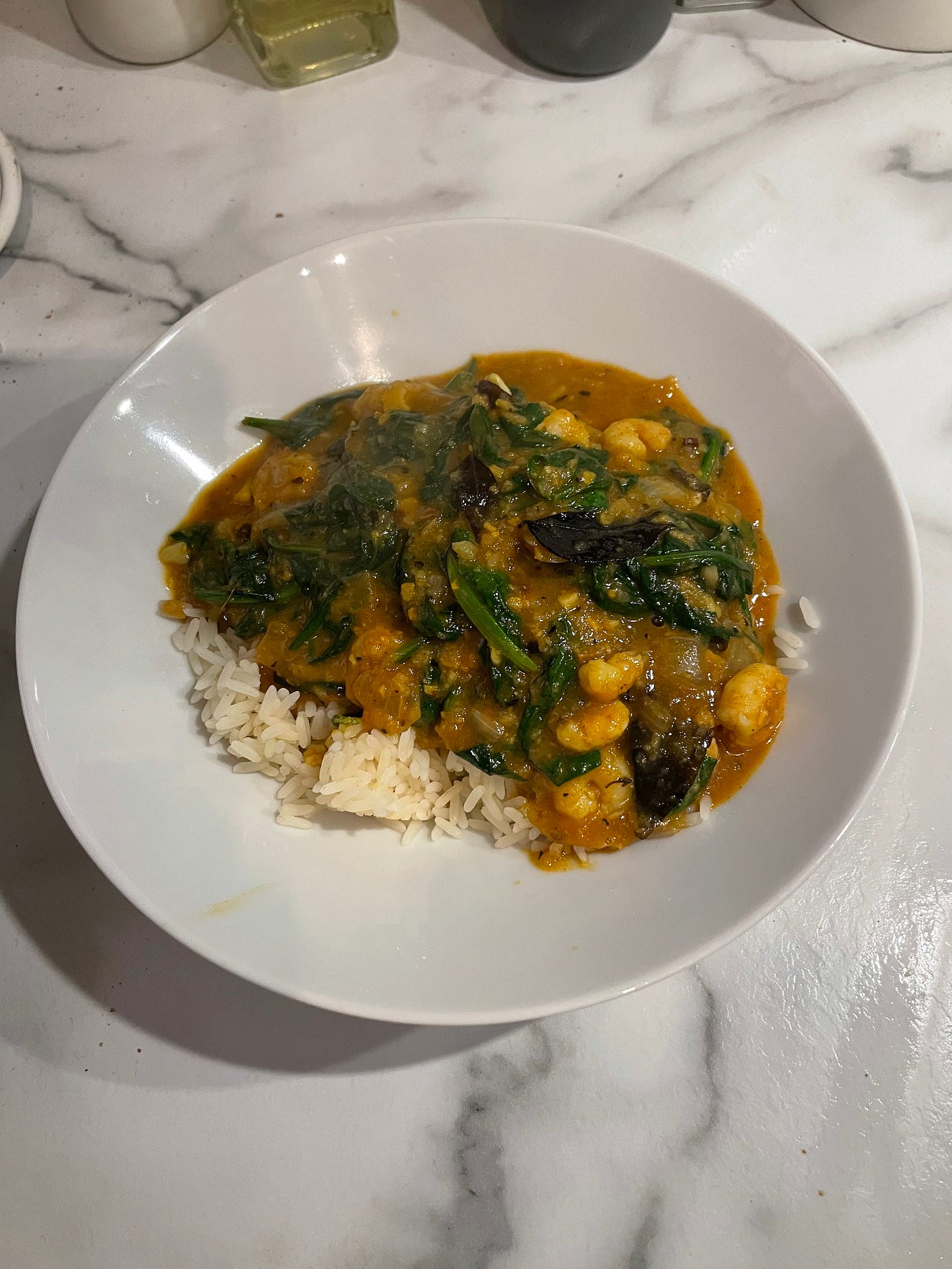 White bowl showing a prawn jhinga curry, perfect for aromatic white wine pairing