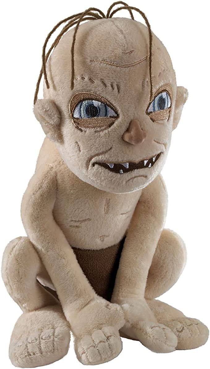 This may contain: a stuffed doll with blue eyes sitting on the ground