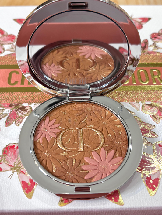 An open Dioriviera 2026 limited-edition eyeshadow palette showcasing embossed floral patterns and Mediterranean shades, including bronze, gold, and azure blue, reviewed for the Tested and Reviewed section.