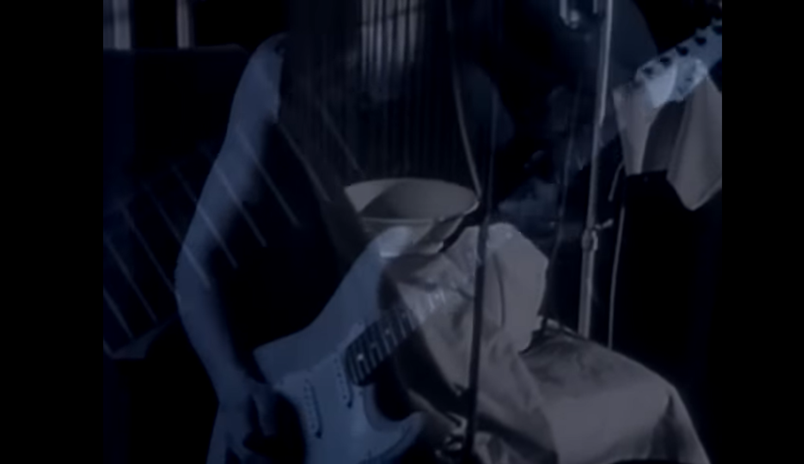 Man playing an electric guitar overlaid atop a man lying in a hospital bed with his face covered.