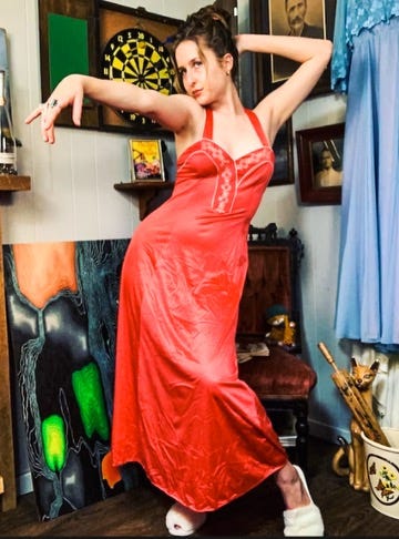A person in a red dress

Description automatically generated