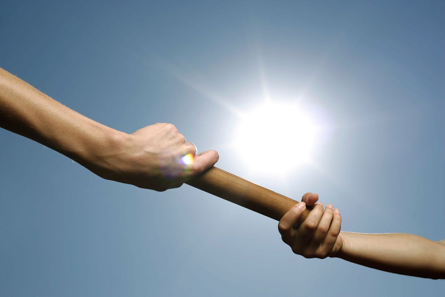 Close-up of hands passing a relay baton, symbolizing cross-functional alignment during a B2B go-to-market rollout strategy. Close-up of hands passing a relay baton, symbolizing cross-functional alignment during a B2B go-to-market rollout strategy.