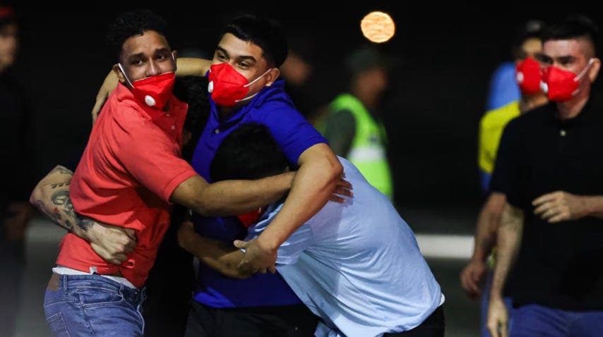A group of men hugging

AI-generated content may be incorrect.