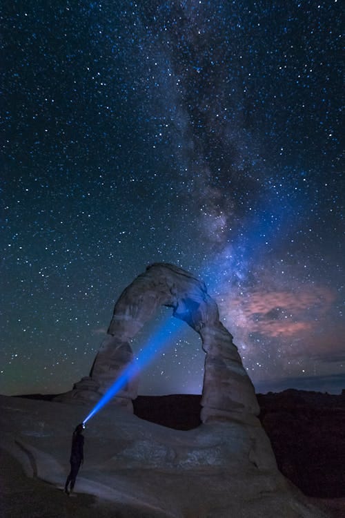 Free Stars on Night Sky over Natural Arch in Arches National Park in USA Stock Photo