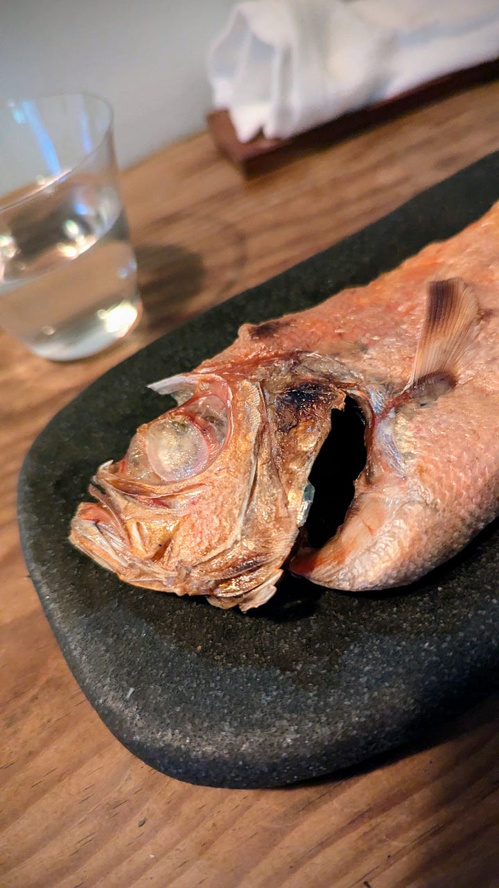 Red-skinned fresh fish, a cooked whole fish, and a painting of a fish on a plate.