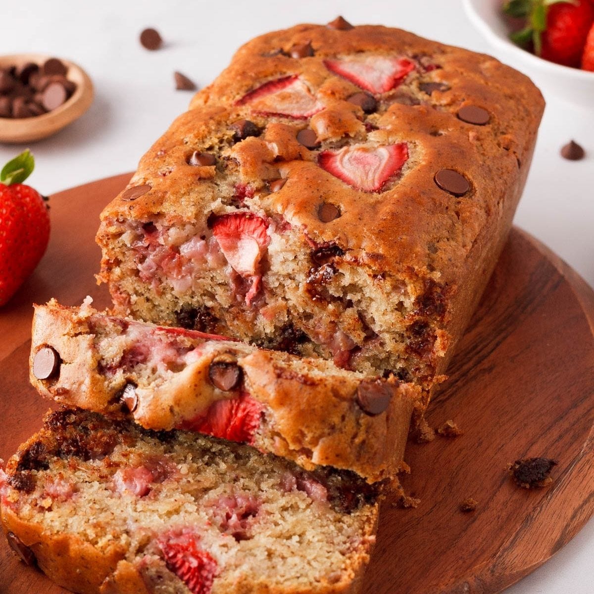 closeup of strawberry chocolate chip bread with a few pieces falling forward closeup of strawberry chocolate chip bread with a few pieces falling forward