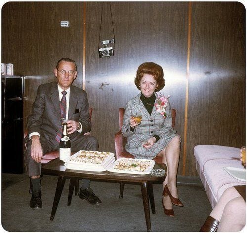 This may contain: two people sitting at a table with food and drinks