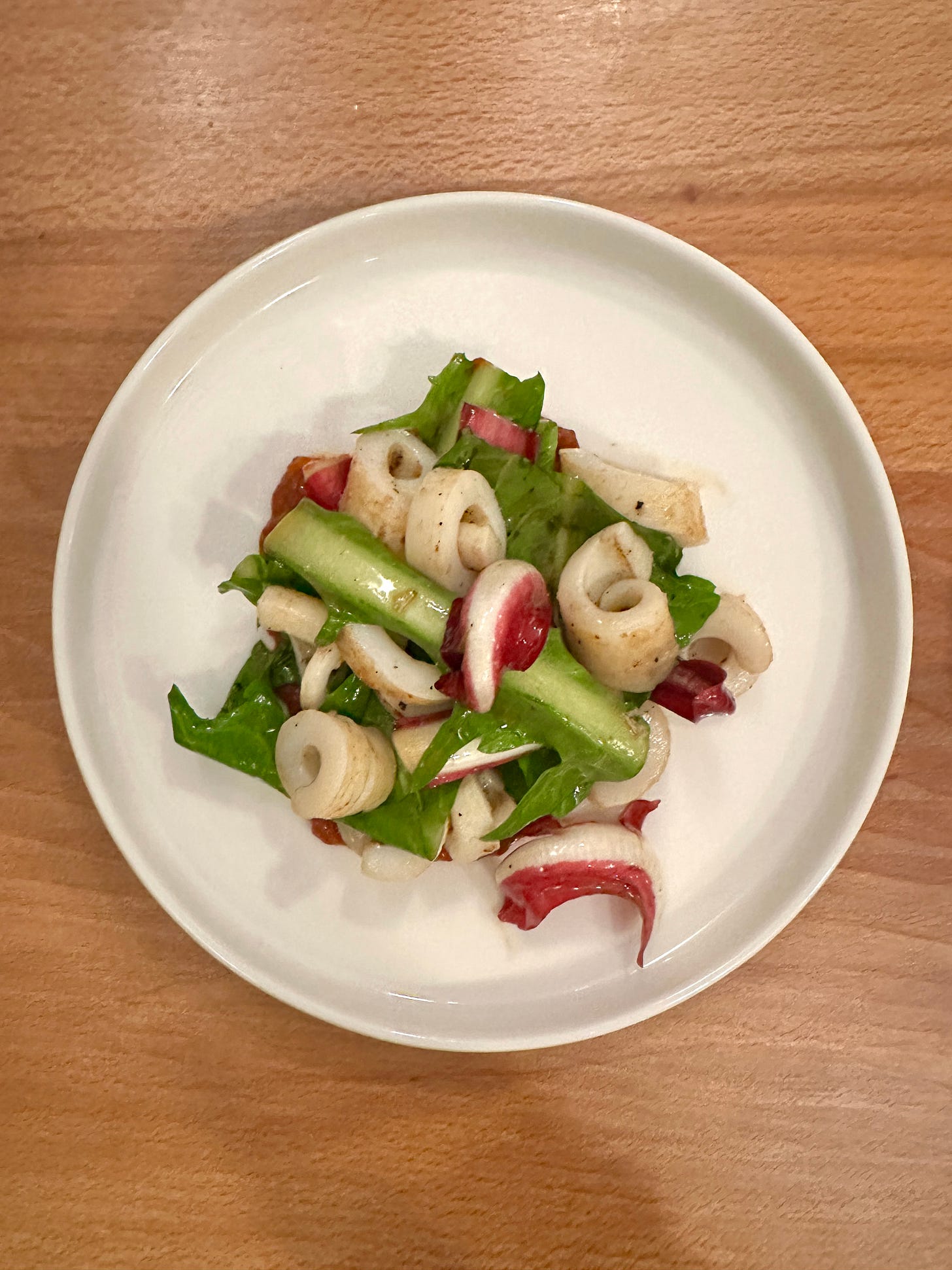 Grilled squid with bitter leaves and romesco at Mongoose