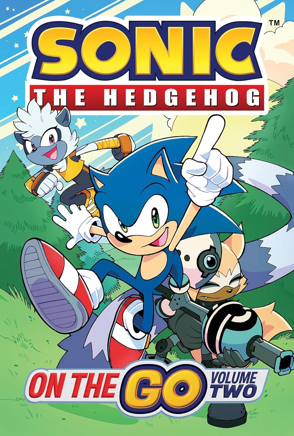 Cover of Sonic the Hedgehog: On the Go Volume Two comic, featuring Sonic striking a dynamic pose with one finger raised while running through a grassy, cartoon forest. Behind him are Whisper the Wolf, Tangle the Lemur, and Tails, each in action-ready stances, conveying energy and excitement. The background includes green trees, a bright sky, and a cheerful atmosphere.