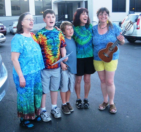 Sharon in 2008 at a Writer's Conference, Sharon with her grandsons, their mom and me at a parking lot singing This Land Is Your Land; Sharon and me when she gave me my t-shirt a few years ago.
