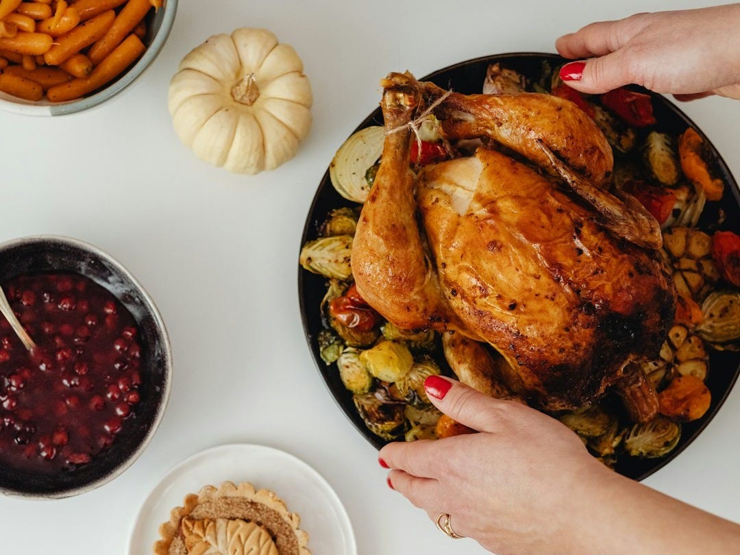 a person holding a plate of food