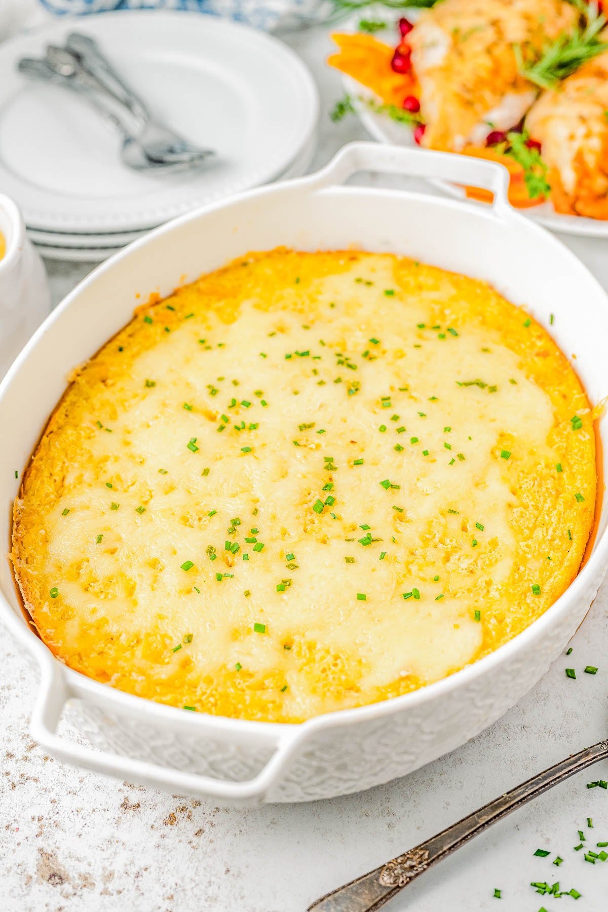 Creamed Corn Casserole in a white casserole dish. Creamed Corn Casserole in a white casserole dish.