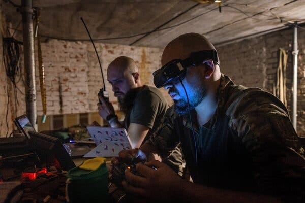 Two soldiers in a bunker, one is wearing goggles. Two soldiers in a bunker, one is wearing goggles.