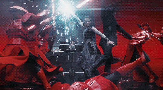 a gif from The Last Jedi where Rey and Kylo Ren fight back to back in the red throne room