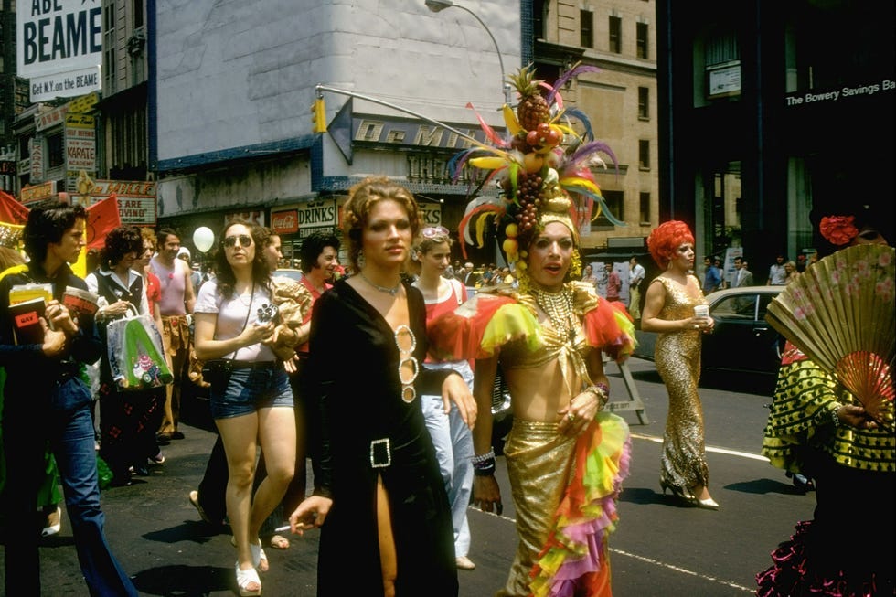 A lively 1970s NYC street parade, vibrant with samba dancers and festive majorettes. A lively 1970s NYC street parade, vibrant with samba dancers and festive majorettes.
