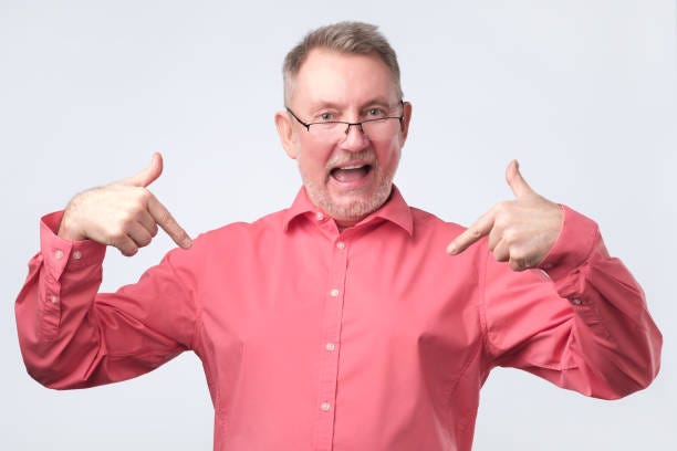 overconfident man in a pink shirt stock photo