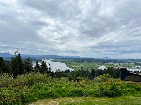 1. Tugboat going under a bridge at sunset. 2. Freighter on the Columbia River. 3. Astoria-Megler Bridger in sunrise. 4. Ships on the Columbia River with pilings. 5. Binoculars. 6. Big ship on the Columbia River. 7. View of the Columbia and Pacific Ocean from the Astoria Column. 8. Photo of Rose smiling from the Astoria Column. 9. View of downtown Astoria and the Columbia River