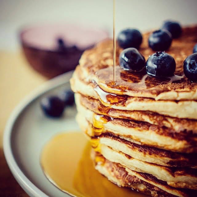 Pancakes with blueberries and maple syrup.