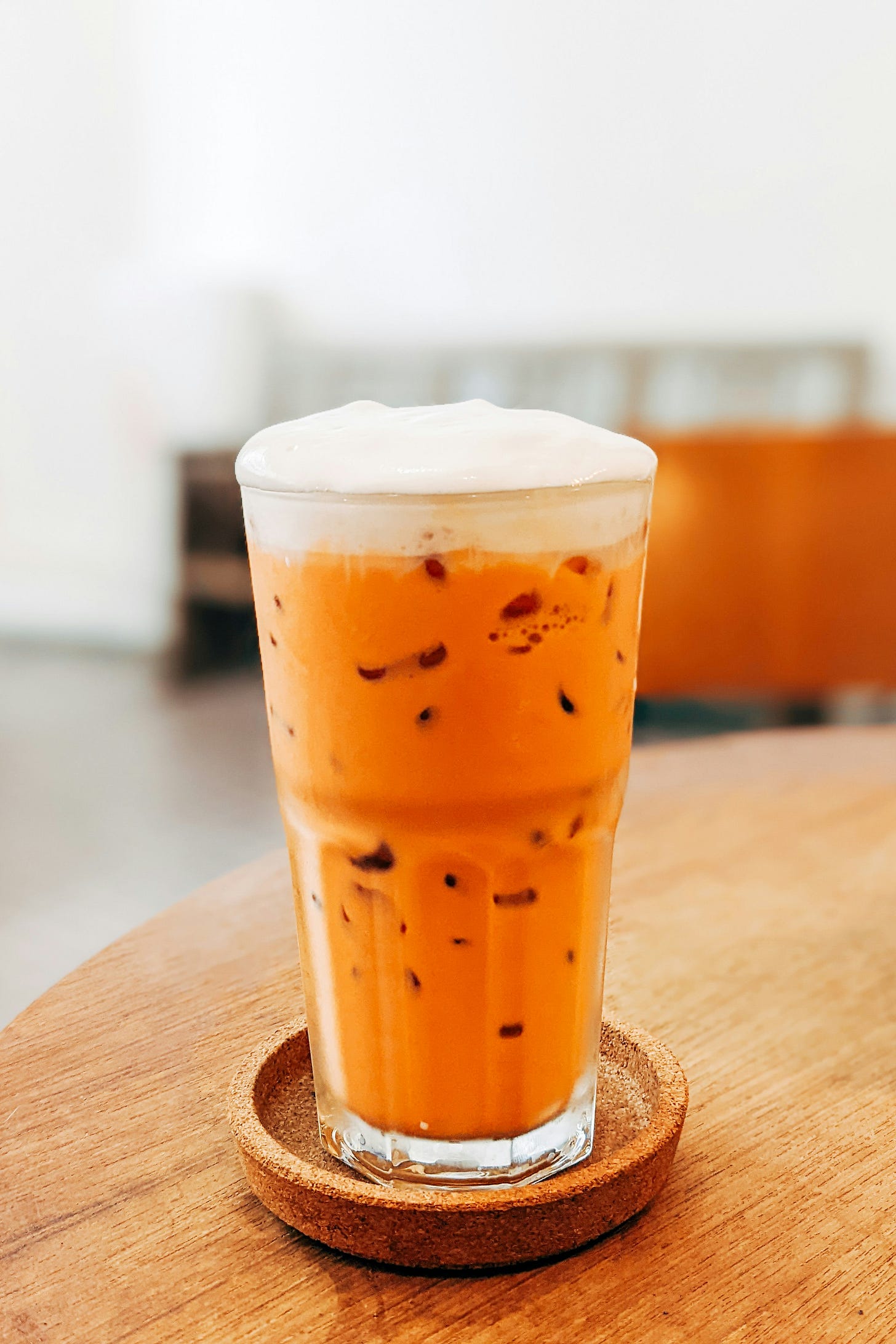 A cup of rich black tea featuring cocoa notes, loose leaves, and mixed herbs on a rustic surface. A cup of rich black tea featuring cocoa notes, loose leaves, and mixed herbs on a rustic surface.