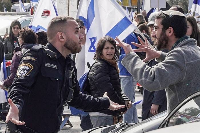 Protesters confront police outside the Knesset earlier this month 