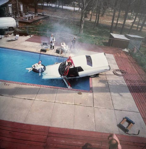 Three images of a car suspended above and dropped into a pool with punk rocker Wendy Williams in the driver seat.