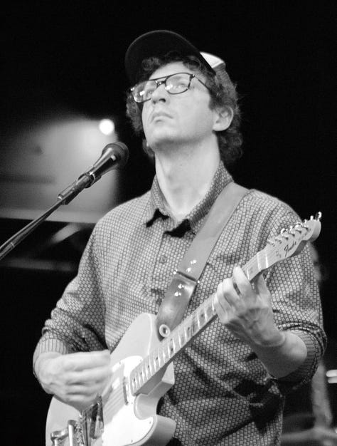 Black-and-white photos of each member of the Tweedy band performing live