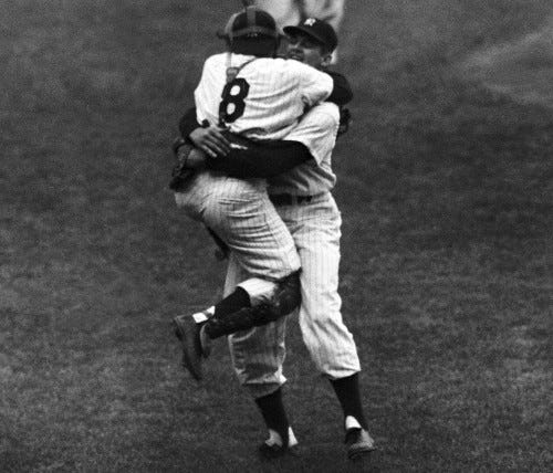 New York Yankees' catcher Yogi Berra leaps into the arms of pitcher Don Larsen after Larsen struck out the last Brooklyn Dodgers' batter to complete his perfect game during the fifth game of the World Series, Oct. 8, 1956. Racing up in the background is Joe Collins. (AP Photo) New York Yankees' catcher Yogi Berra leaps into the arms of pitcher Don Larsen after Larsen struck out the last Brooklyn Dodgers' batter to complete his perfect game during the fifth game of the World Series, Oct. 8, 1956. Racing up in the background is Joe Collins. (AP Photo)