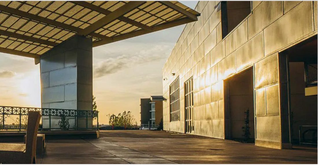 University building with clouded sun in background University building with clouded sun in background