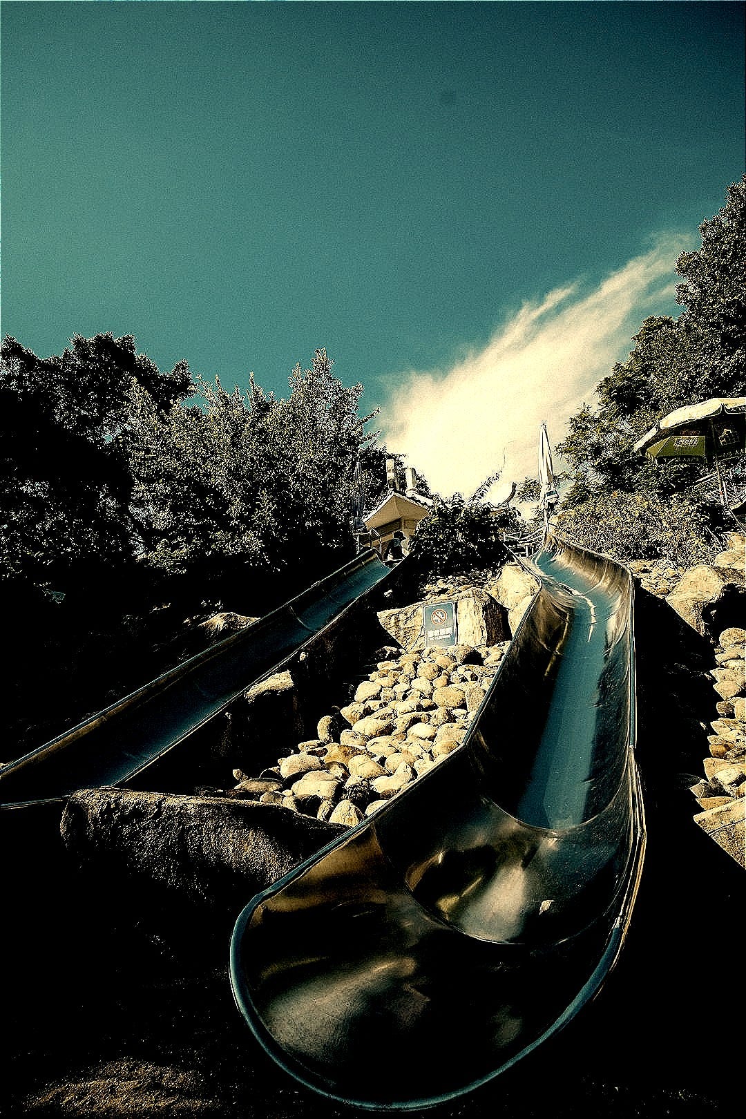 Two metal slides on a sunny day Two metal slides on a sunny day