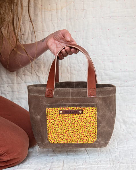 waxed canvas tote with vegetable tanned leather and antique textiles