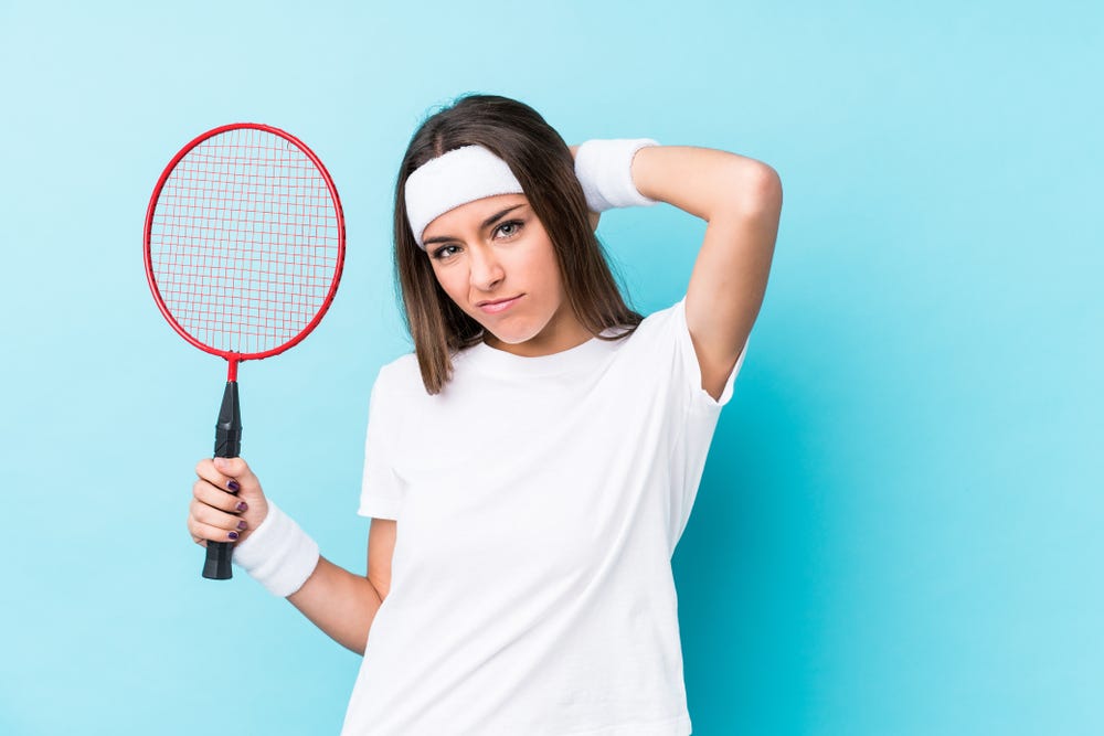 Young woman holding a badminton racket