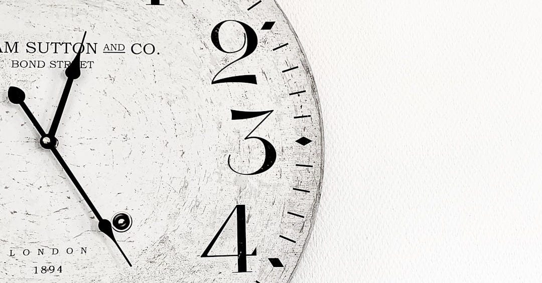 white analog wall clock at 10 00