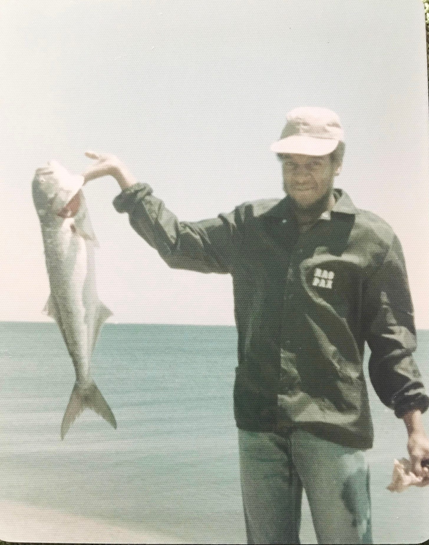 Vintage photo of a father fishing by the ocean in Virginia Beach, representing generational legacy, coastal family traditions, and the roots behind The Soul Food Pot® storytelling and recipes