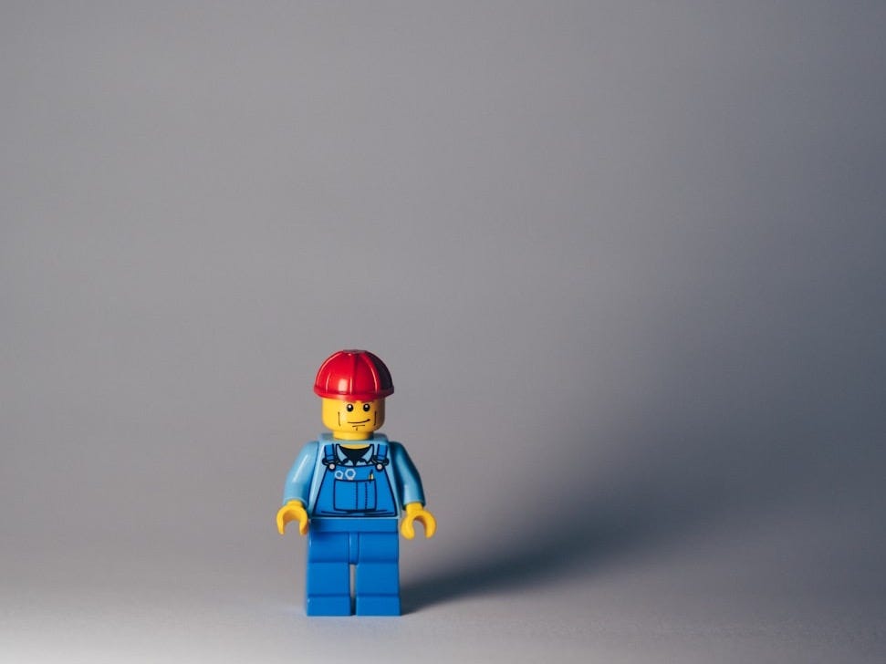 lego minifig on white surface lego minifig on white surface