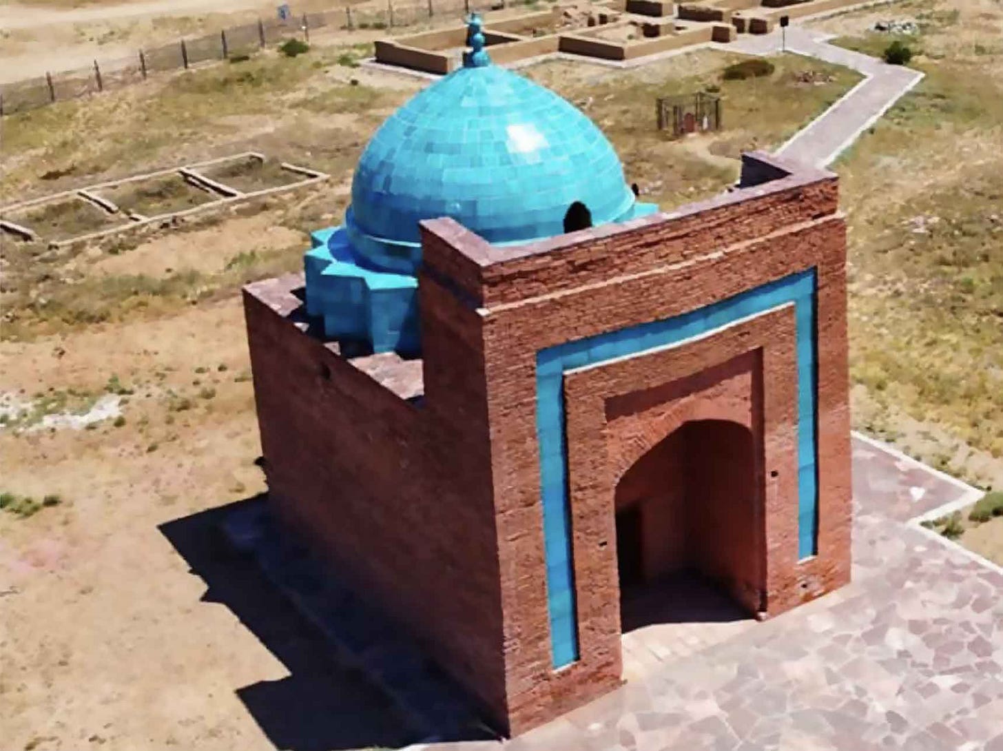 Brick mausoleum with blue tile decor and dome