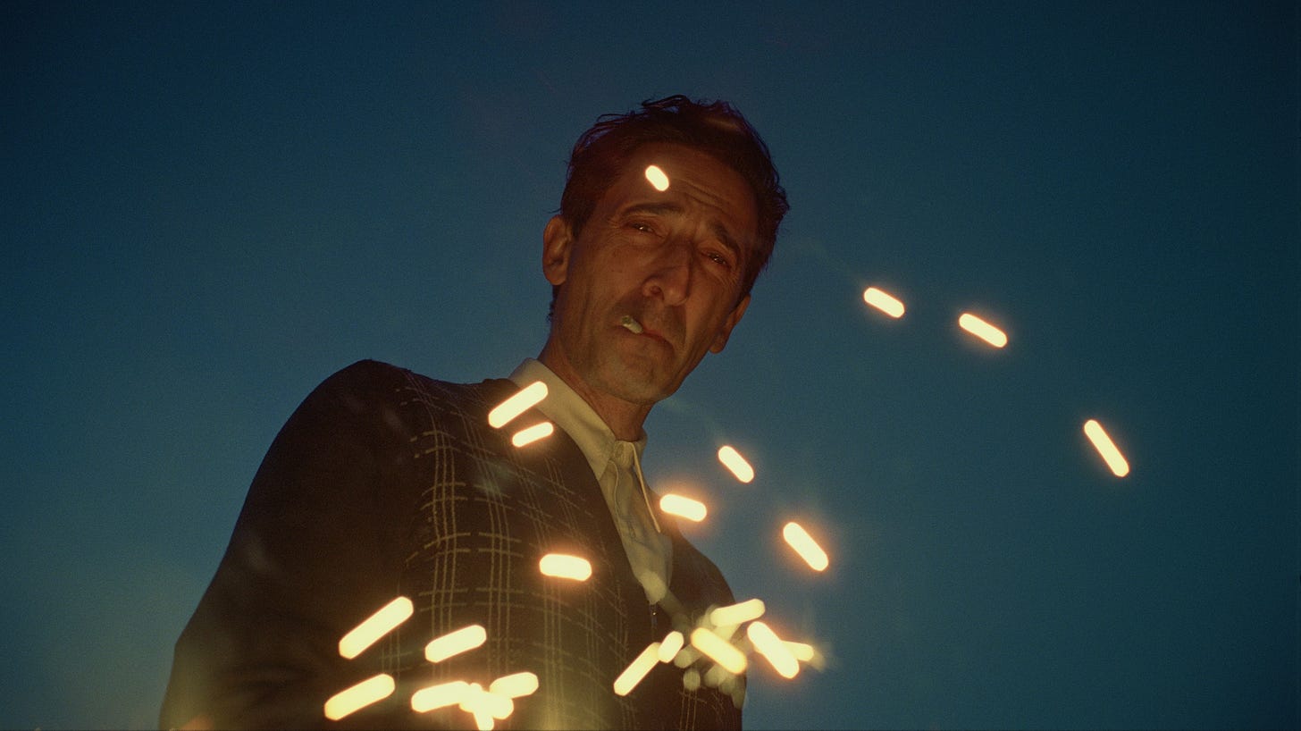 Image may contain Adrien Brody Lighting Photography Face Head Person Portrait Adult Light Flare Nature and Night