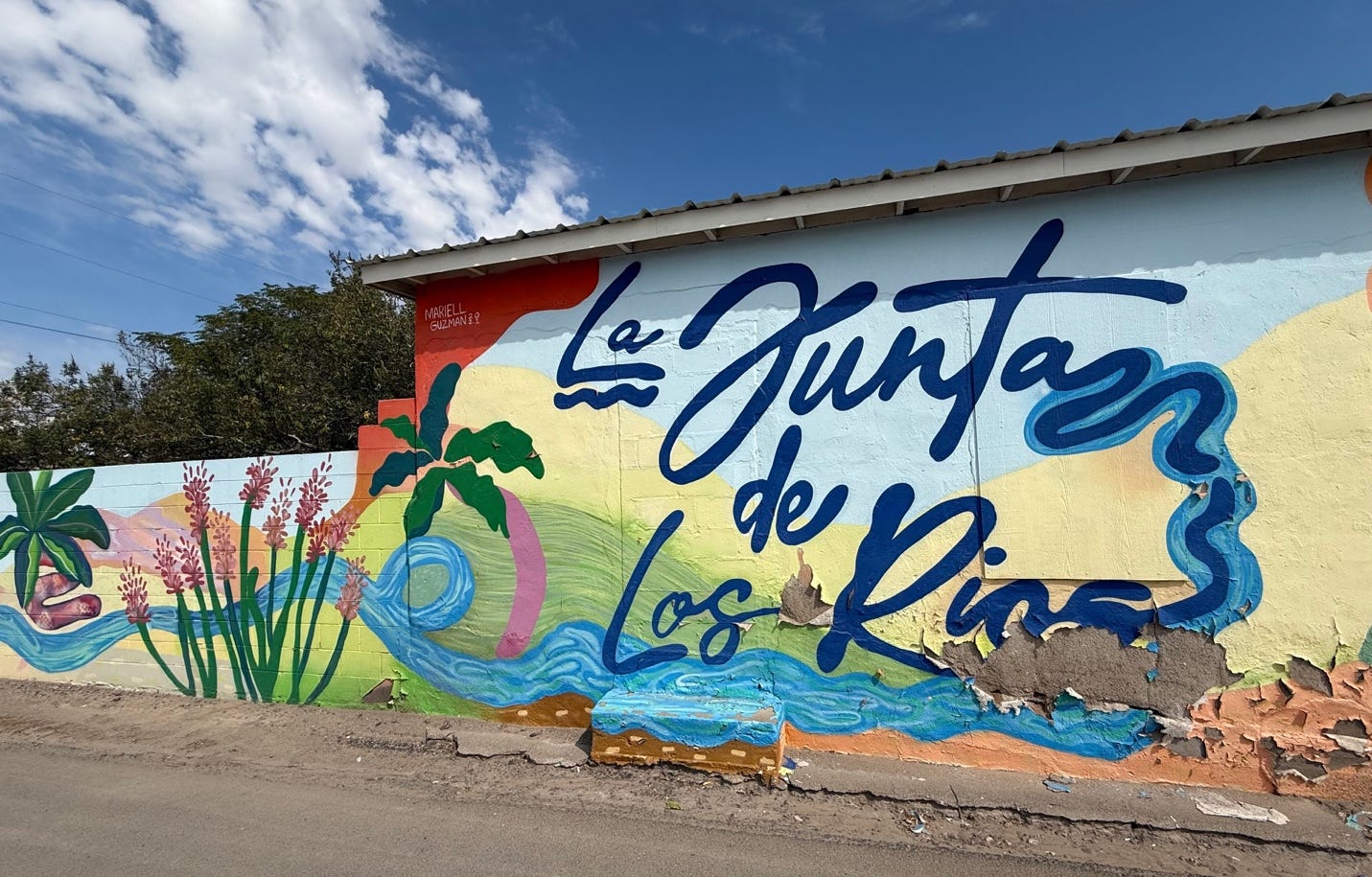 A wall painted with blue text

AI-generated content may be incorrect.