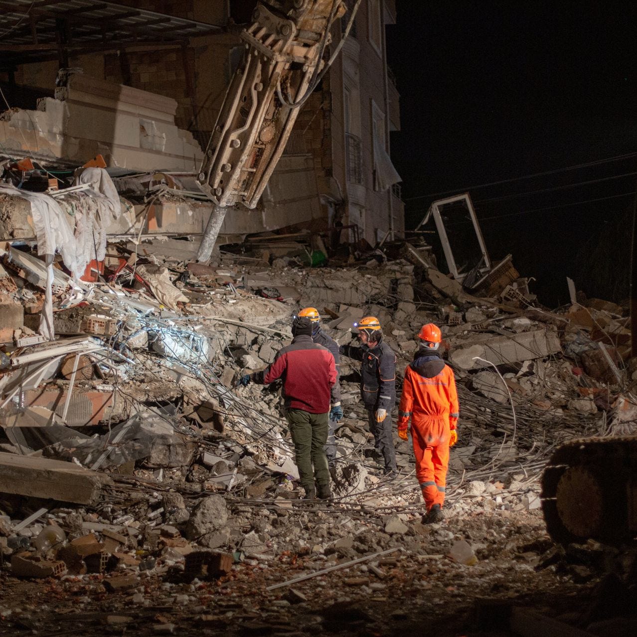 Rescuers search through the rubble in the southeastern Turkish town of Belen.