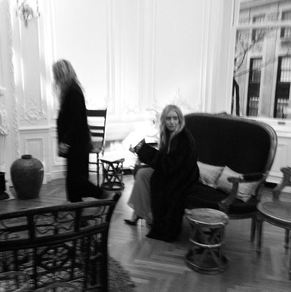 This may contain: black and white photograph of two women in a living room This may contain: black and white photograph of two women in a living room