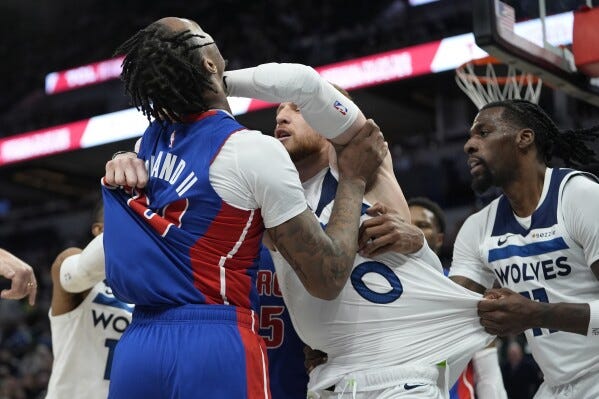 Detroit Pistons forward Ronald Holland II (00) left, and Minnesota Timberwolves guard Donte DiVincenzo, middle, fight during the first half of an NBA basketball game, Sunday, March 30, 2025, in Minneapolis. (AP Photo/Abbie Parr) Detroit Pistons forward Ronald Holland II (00) left, and Minnesota Timberwolves guard Donte DiVincenzo, middle, fight during the first half of an NBA basketball game, Sunday, March 30, 2025, in Minneapolis. (AP Photo/Abbie Parr)