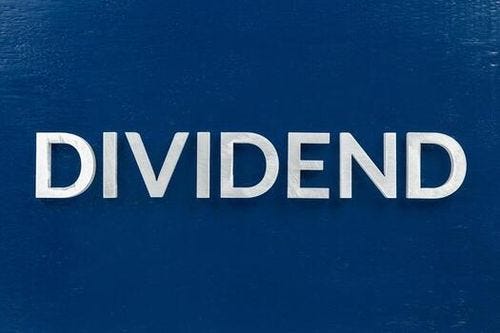 the word dividend laid with brushed metal letters on dark blue background photo the word dividend laid with brushed metal letters on dark blue background photo