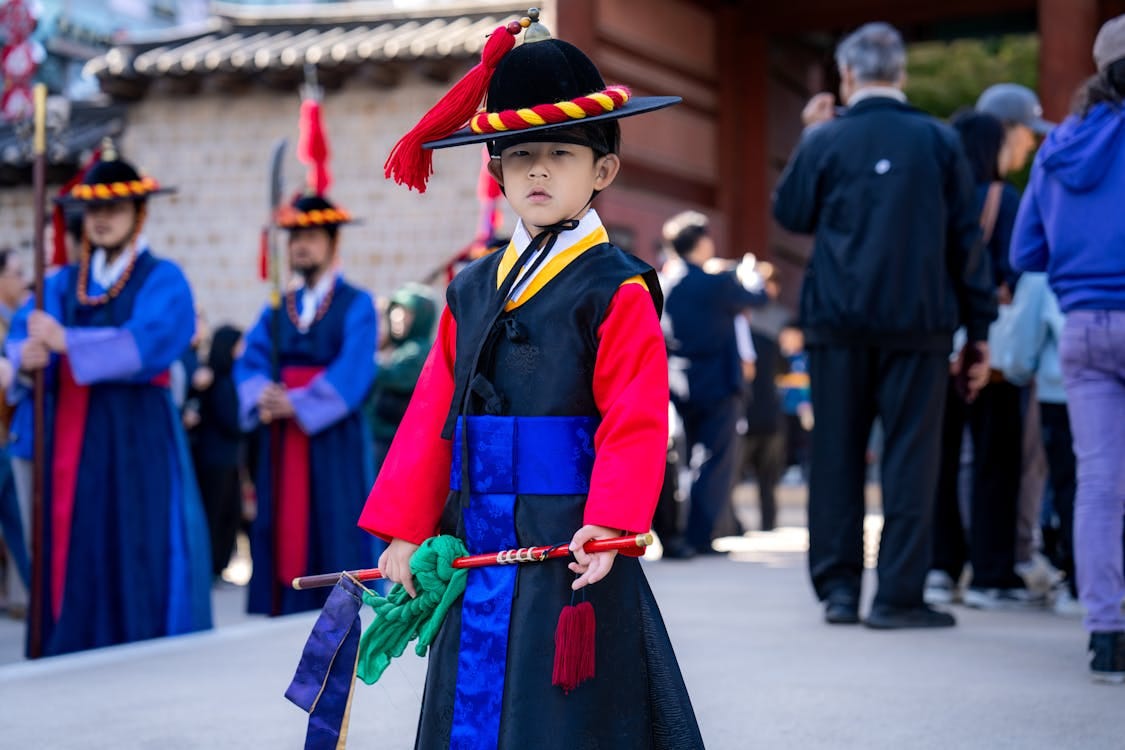 Free Young boy in traditional Korean hanbok during a cultural parade in Seoul, South Korea. Stock Photo