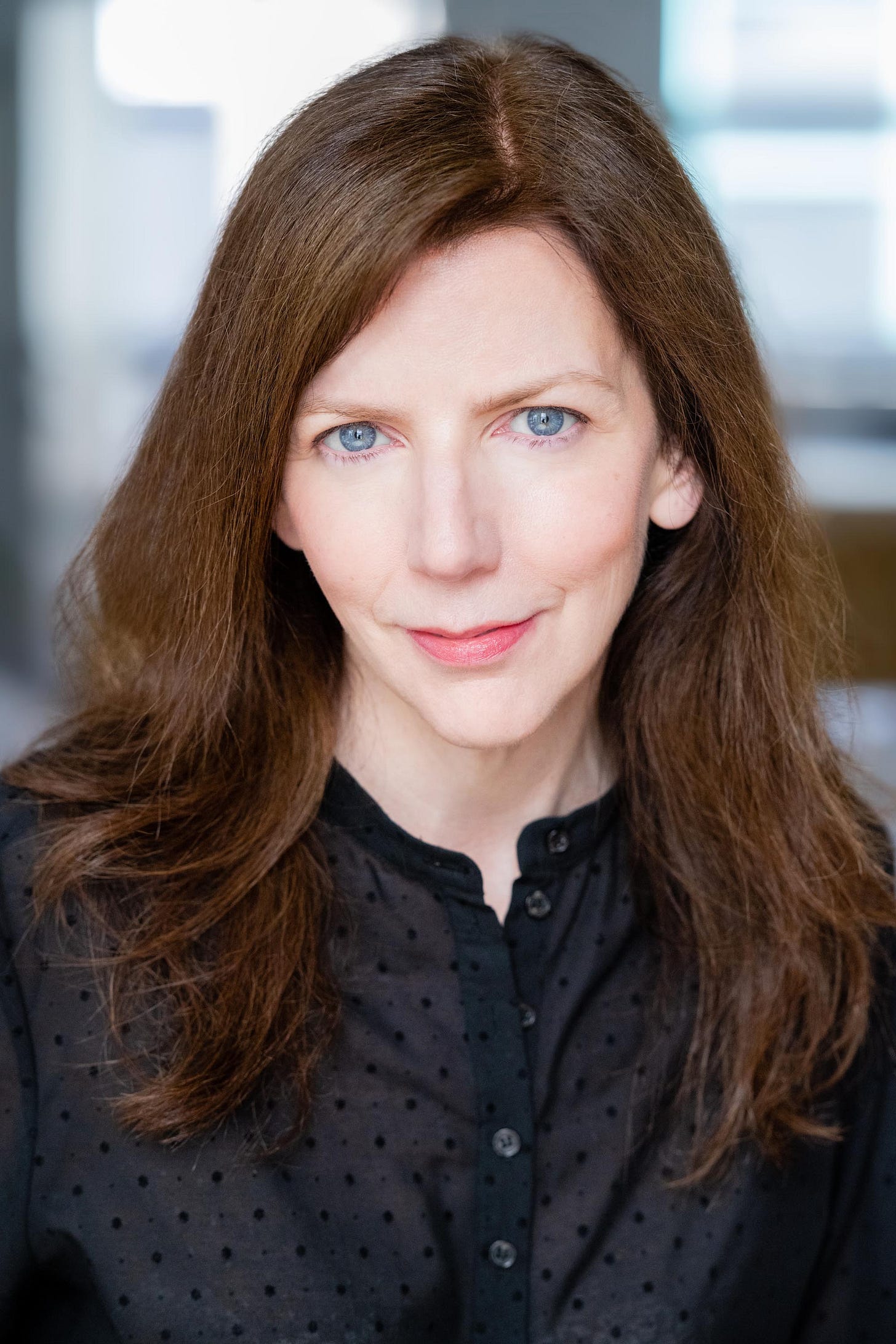 Suzanne Scanlon, author of Committed: On Meaning and Madwomen, poses for a headhsot. Her blue eyes stare out as she smiles. 